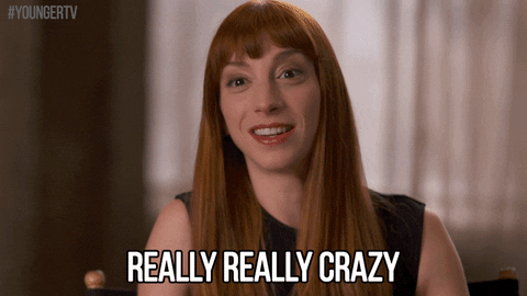 TV gif. Molly Bernard as Lauren Heller on Younger looks at us with a big smile on her face. She scratches her cheek as she says, “Really, really crazy.”