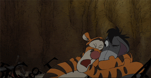 Disney gif. An excited Tigger tightly hugs Eeyore's head, but Eeyore seems vaguely uncomfortable.
