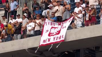Crowd Member Hangs A Banner