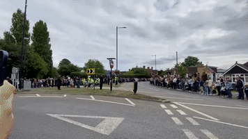 Crowd Cheers as Queen's Coffin Travels Through Windsor