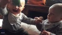 Brothers in Arms: Twins Pause Playtime for a Hug