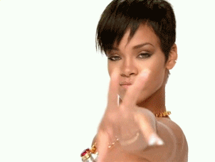 Celebrity gif. Rihanna looks at us, reaching her hand out and moving it like she’s casting a spell. Cut to a close up of her face as she winks suggestively. She smirks as the camera slides away.