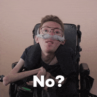 Reaction gif. A mobility-impaired white man using a power chair, a ventilator, and wearing retro-crossbar glasses raises an eyebrow with guarded eyes, asking, "No?"
