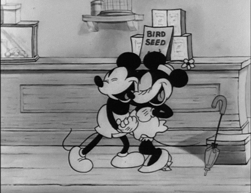 a scene from Mickey mouse where Mini and Micky are dancing together looking very happy