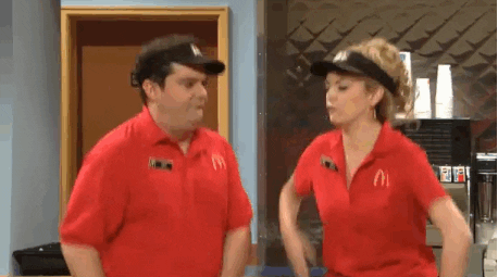 SNL gif. From the "McDonald's Firing" sketch, Bobby Moynihan and Cecily Strong do a high-five and spin around.