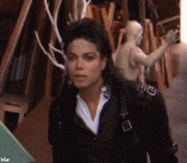 Celebrity gif. Michael Jackson is peering at something with fascination and he steps towards it. He looks closer and scrunches his face in disgust as he steps back slightly, repulsed.