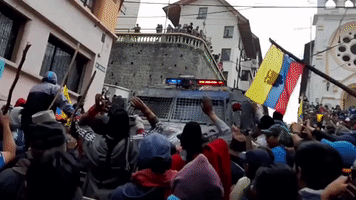 Protesters Block Police Vehicle and Flee Tear Gas in Quito