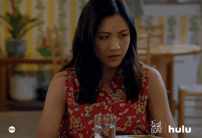 TV gif. Constance Wu as Jessica from Fresh Off The Boat. She raises her hands and drops her face into her palms as she sits at the table.