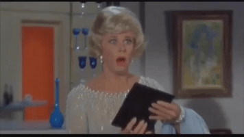 Movie gif. Doris Day as Carol Templeton on Lover Come Back holds a wallet open and she looks at someone with a worried expression. Her eyes widen as she thinks a little bit more, and she starts to get angry, looking around as she says, “Oh. Oh. Oh. Oh. Oh!”