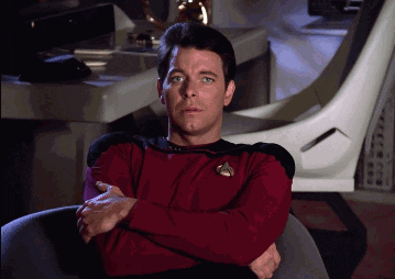 TV gif. Jonathan Frakes as Riker in Star Trek sits in a chair with his arms crossed and he's visibly annoyed as he sighs and prepares to get up.