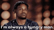 Video gif. Kevin Holland sits for an interview, furrowing his brow as he says with conviction, "I'm always a hungry man."
