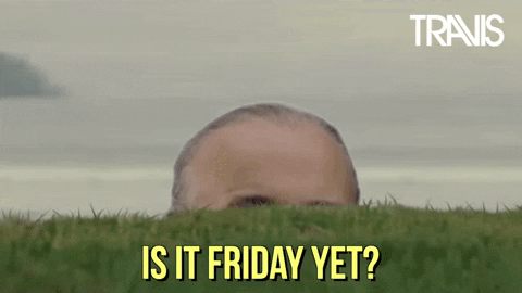 Celebrity gif. Fran Healy from the band Travis peeks over a wall of grass. Text, “Is it Friday yet?”