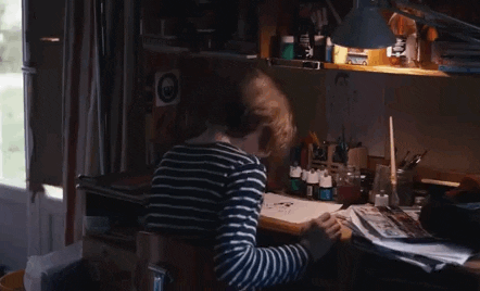 Movie gif. Ange Dargent as Daniel in Microbe & Gasoline sits at a desk surrounded by art supplies, banging his head against the desk.