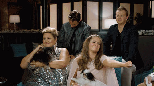 TV gif. Cast of Inside Amy Schumer are spoofing Real Housewives and they're all dressed up in huge wigs. Two people hug and say, "I miss you so much. I miss you. I miss you the most."