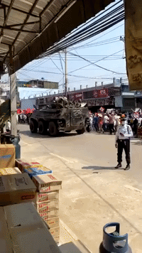 Military Vehicles Drive Past Demonstrators as Myanmar Protests Continue