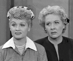 TV gif. Lucille Ball as Lucy tilts her head, raises her eyebrows, and frowns skeptically while Vivian Vance as Ethel glances to the side uncertainly beside her.