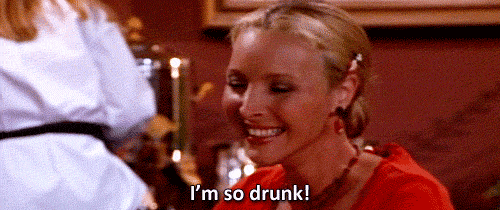 Friends gif. Lisa Kudrow as Phoebe blinks hard and smiles slightly as she says, "I'm so drunk!" which appears as text.
