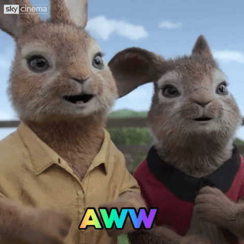 Movie gif. Flopsy and Mopsy in Peter Rabbit rest their heads on each other and smile as they say, "Aww."