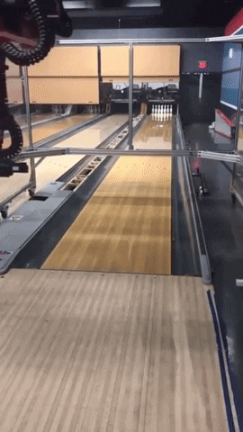 robot bowling man vs machine GIF
