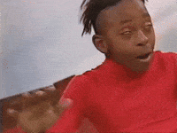 Video gif. Person with a duck tail hairstyle and wearing a tight red turtleneck leans back and flails their arms, rolling their eyes back as if they're being blown away by the wind.