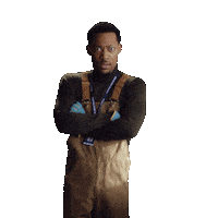 Sponsored gif. Sticker of Tyler James Williams as Gregory Eddie on Abbott Elementary standing stiffly, arms crossed, widening his eyes in a show of assertiveness.
