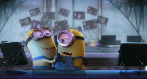 Despicable Me gif. A taller minion picks up a shorter minion and hugs him–shaking him as he squeezes him with love. At first the shorter minion is shocked and then he smiles. 