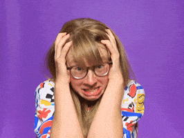 Meme gif. Woman with long blonde hair and glasses clutches at her scalp, exploding and screaming.