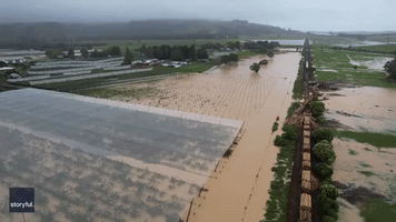 Drone Footage Shows Train Derailed in New Zealand Floodwaters