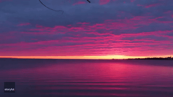 'Awesome' Purple Sunrise Reflected in Calm Waters of Lake Superior