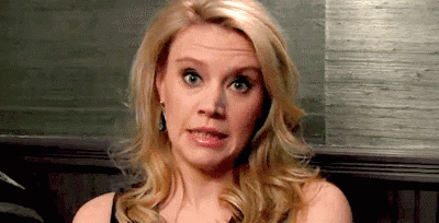 Celebrity gif. Kate McKinnon winces an exaggerated frown as her head lowers in a cringe. 