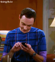 TV gif. Jim Parsons as Sheldon on The Big Bang Theory looks down at his phone as he texts and says, "LOL."