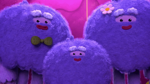 Cartoon gif. Three yetis from True and the Rainbow Kingdom simultaneously applauding and smiling.