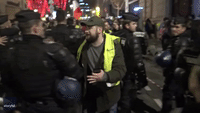 Yellow Vests and Police Share New Year's Hugs in Paris