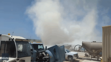 Large Dust Devil Swirls Around Trucks in South Texas