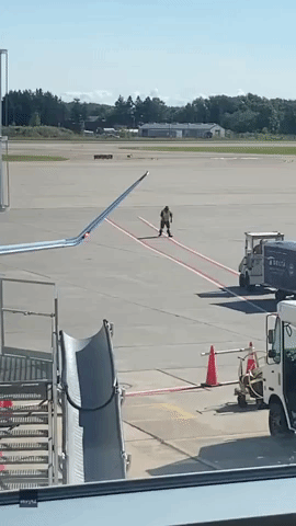 Airport Worker Shows Off Baton Skills on Runway