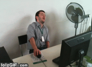 Video gif. A man sits in front of a computer with his hand on the mouse, falling asleep and then tipping over onto the ground, taking the mouse with him.