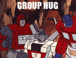 Cartoon gif. Three transformers embrace beneath the flashing text, “Group hug.”