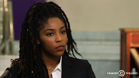 TV gif. Jessica Williams on the Daily Show shakes her head and throws her hands up disappointedly.
