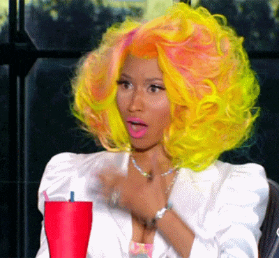 Celebrity gif. Nicki Minaj pulls back in astonishment and slight amusement, hand to her chest, mouth agape.