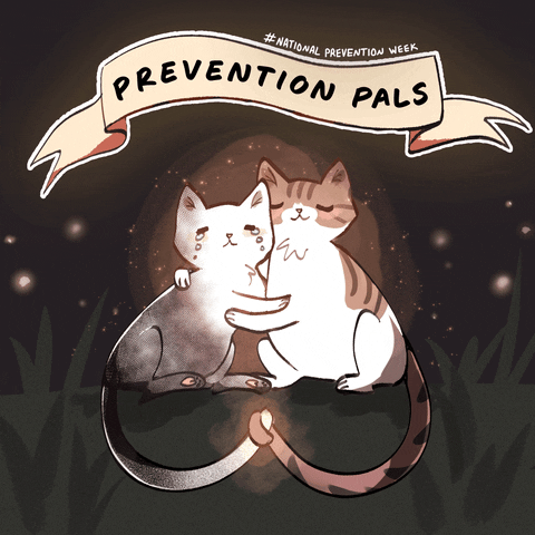 Digital art gif. Two cartoon cats hold each other lovingly, one with tears on its face and the other smiling reassuringly. Text in a ribbon above the cats reads, "Prevention Pals."
