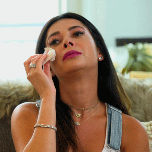 Reality TV gif. Married at First Sight star Alyssa Ellman dramatically dabs her seemingly dry eyes with a tissue.