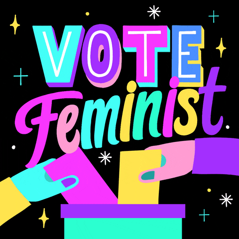 Digital art gif. Two colorful hands drop ballots into a ballot box against a black background. Colorful text surrounded by several sparkling stars reads, “Vota Feminista, Vote Feminist.”