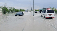 Cars Plow Through Flooded Streets in Greater Doha