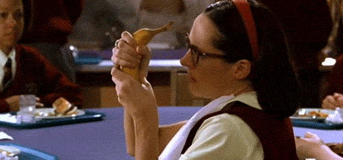Movie gif. Molly Shannon as Mary in Superstar looks angrily over at us while she squeezes a banana with both hands and its contents burst out of the peel.