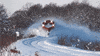 Video gif. Train equipped with snow plows rolls down a snow-covered track, pushing all the snow out of its way and leaving behind a cloud-like trail of snow in the air.