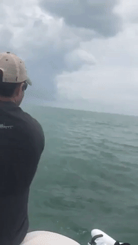 Bull Shark Attacks Tarpon Close to Man's Boat