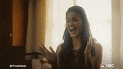 TV gif. Mandy Moore as Rebecca in This Is Us laughs and claps with joy.