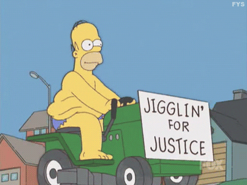 The Simpsons gif. Wearing only denim cutoff shorts, a smiling Homer drives along the street on a green riding lawn mower. The movement causes the fat on his sides to ripple, and a sign at the front of the lawnmower reads, "Jigglin' for justice"