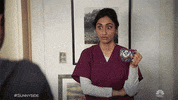 TV gif. Kiran Deol as Mallory in Sunnyside crosses her arms with a mug in one hand as she looks surprised, then rolls her eyes to the side with a cringe and a look of embarrassment.