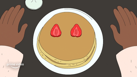 Cartoon gif. Chocolate sauce squirts a smile onto a stack of pancakes with strawberry eyes.